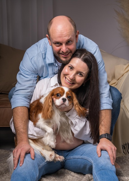 Happy family with dog Cavalier King Charles Cocker Spaniel