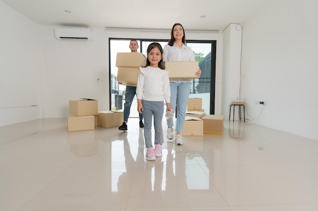 Happy family with girl moving into a new home