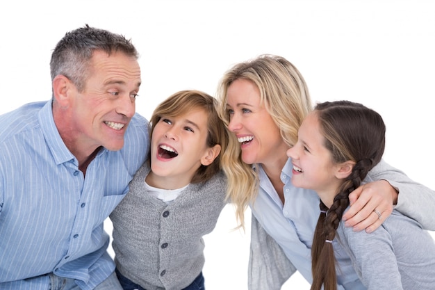 Happy family with two children smiling and hugging