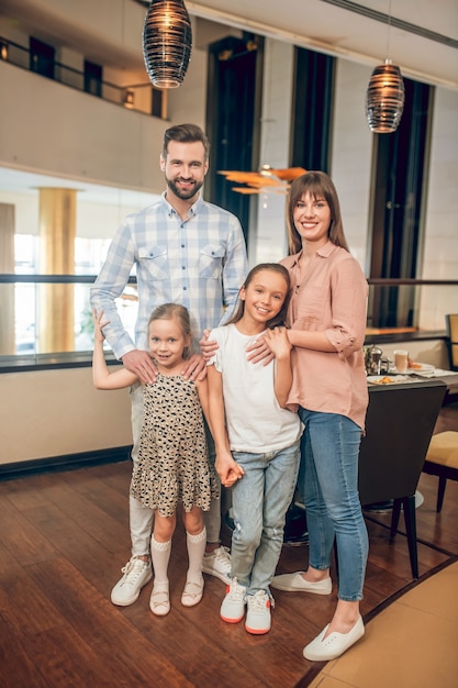 Happy family. Young sweet family standing and looking happy