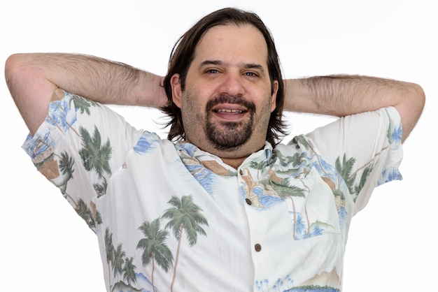 Happy fat Caucasian man smiling with arms raised on head isolated on white