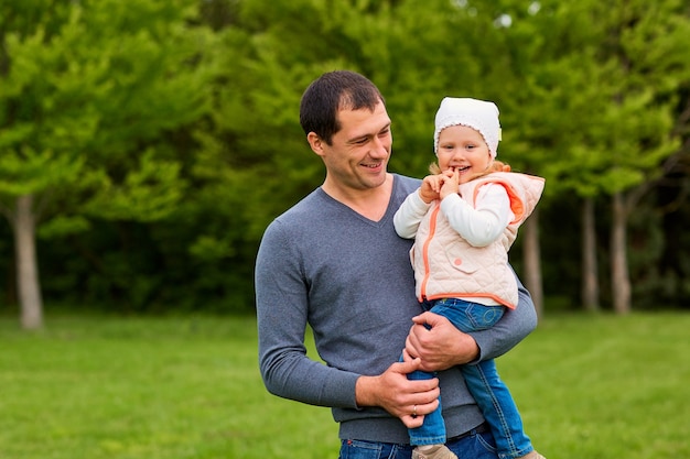 Happy father and daughter in the park smilinglaughing and happiness