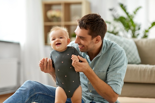 happy father holding little baby daughter at home