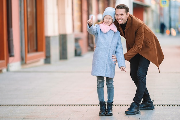 Happy father and little adorable girl in the city outdoors