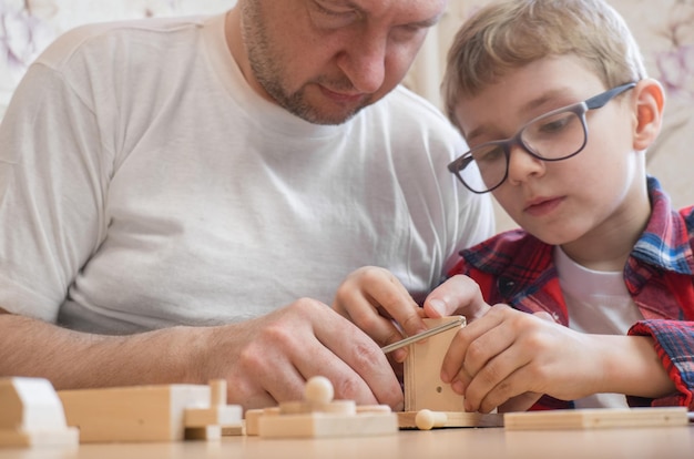 Happy father's day and childhood concept Father and sonboy in glasses work with hand tools using