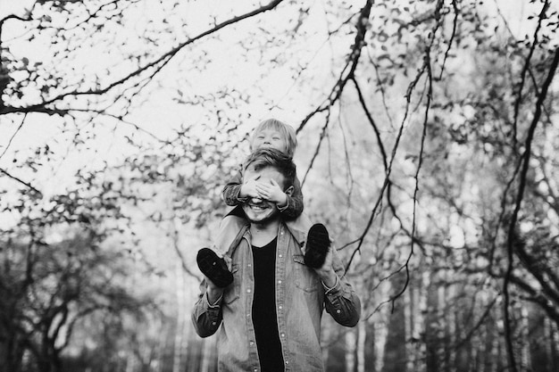 Happy father and son having fun in autumn park