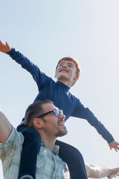 Happy father and son playing togetherphoto with copy space