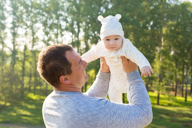 Happy father with the child in the field