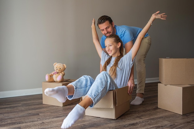 Happy father with daughter have fun in their new home Family enjoy their moving day