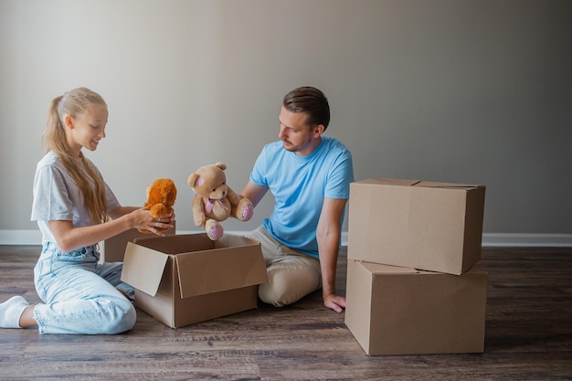 Happy father with daughter have fun in their new home Family enjoy their moving day