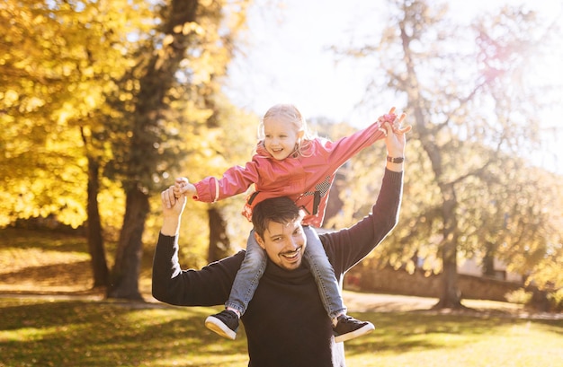 Happy father with little daughter in autumn park outdoor recreation Father and daughter