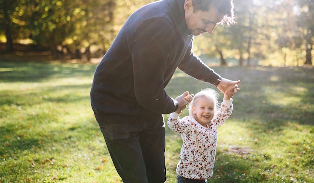 Happy father with little daughter in autumn park outdoor recreation Father and daughter