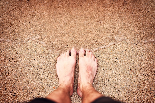 Happy feet at the beach High angle shot of an unrecognizable womans feet at the beach