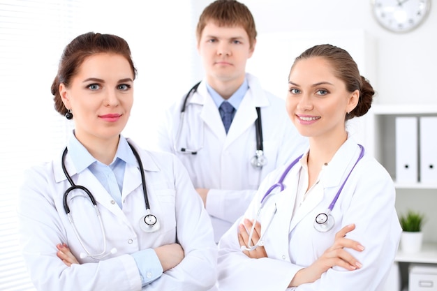 Happy female doctor with medical staff at the hospital