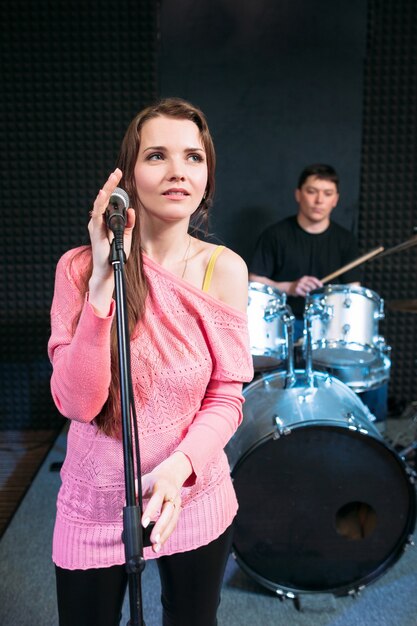 Happy female singer on stage holding microphone