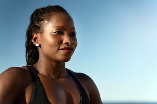 Happy female in sport outfit looking away and smiling