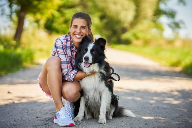 happy female strolling with her pet at leisure