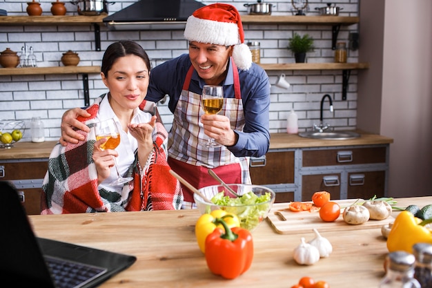 Happy festive man and woman in kitchen. 