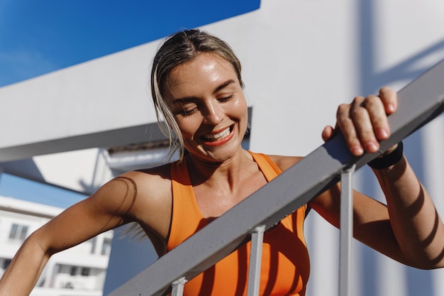 Happy Fitness Woman Running by a Staircase During Her Intense Workout