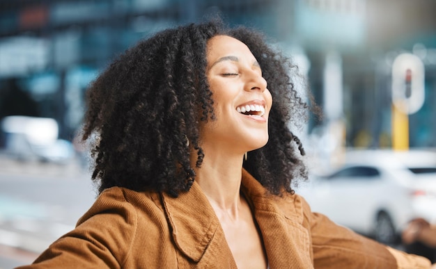 Happy freedom and black woman in a city for travel vacation and holiday against an urban background Smile free and living girl in New York for break explore and journey with happiness and mockup