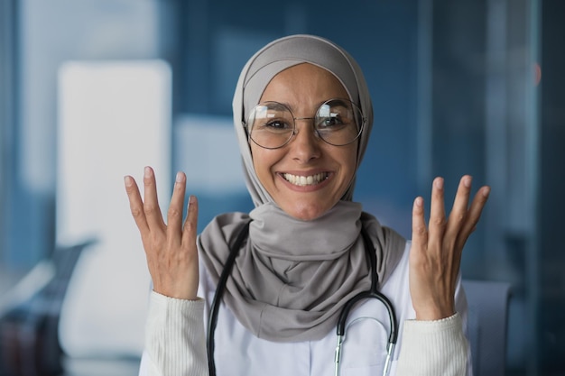 Happy and friendly young beautiful woman doctor student muslim arabic standing in hijab glasses and