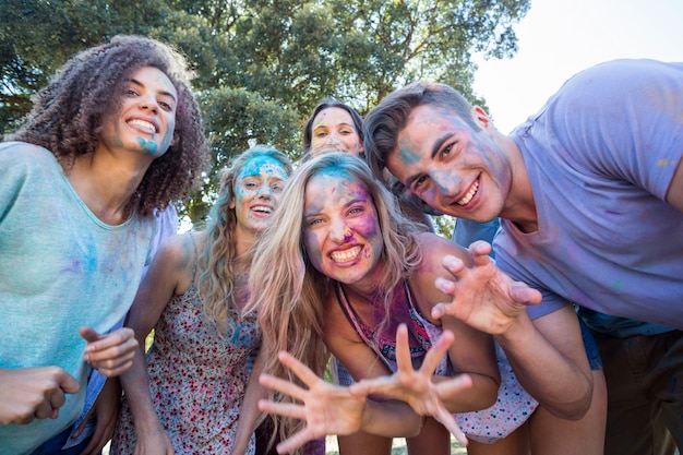 Happy friends covered in powder paint