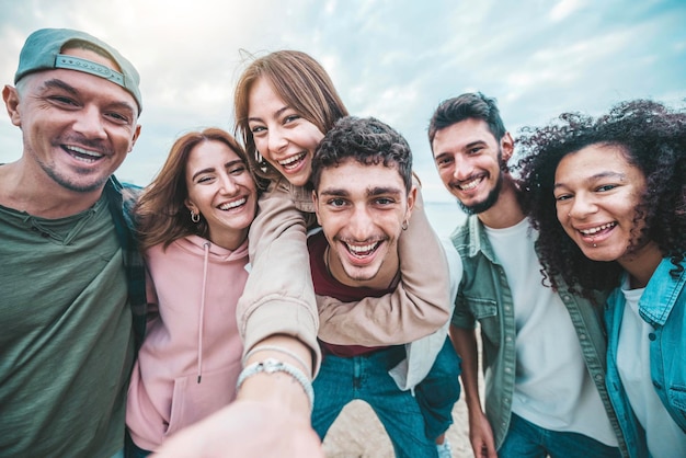 Happy friends group taking selfie picture outdoors