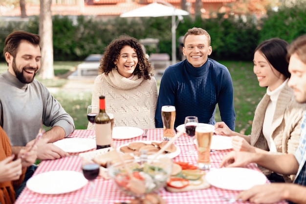 Happy friends have fun, they cook food.