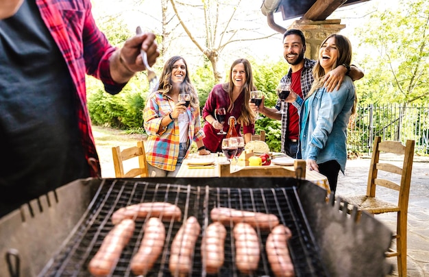 Happy friends having fun at picnic barbecue garden party