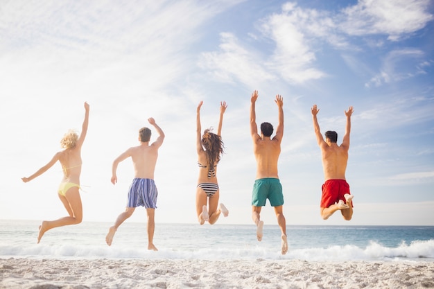 Happy friends jumping together