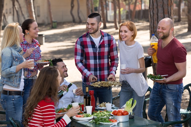 Happy friends making grill &#xA;