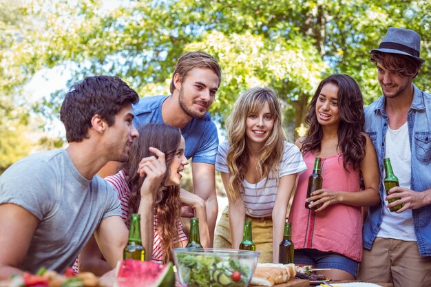 Happy friends in the park having lunch