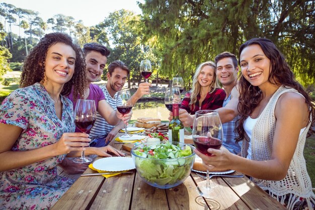 Happy friends in the park having lunch