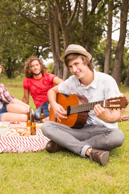 Happy friends in the park having picnic