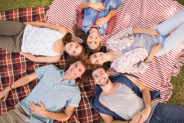 Happy friends in the park having picnic