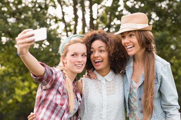 Happy friends in the park taking selfie