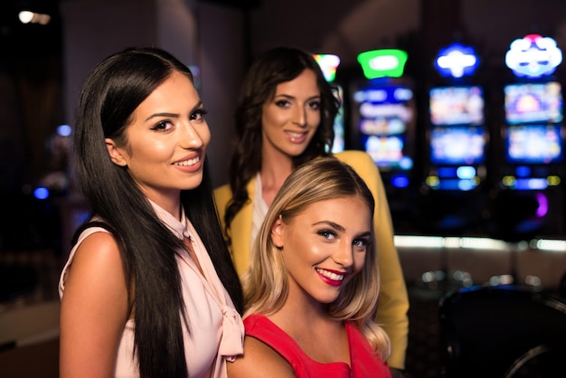 Happy Friends Playing Arcade Machine in a Casino