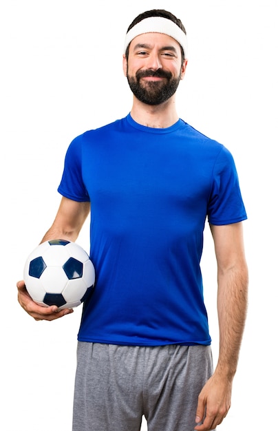 Happy Funny sportsman holding a soccer ball on isolated white background