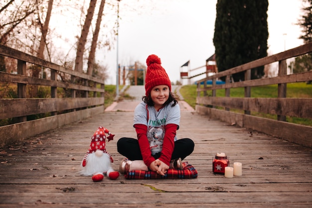 Happy girl celebrating christmas with lights and christmas elements