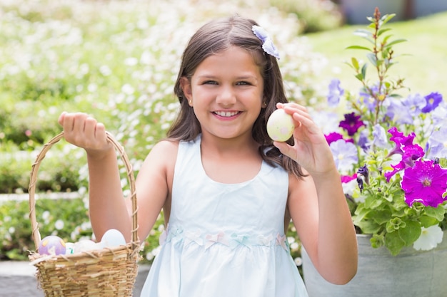 Happy girl collecting easter eggs