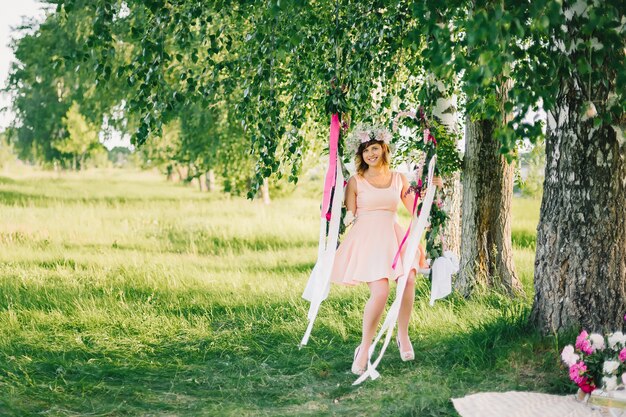 Happy girl on a decorated swing