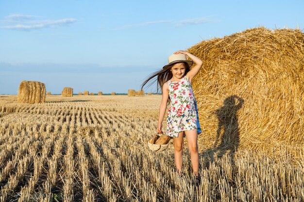 Happy girl on field of wheat