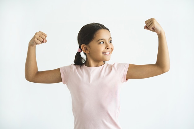 The happy girl gesturing on the white background