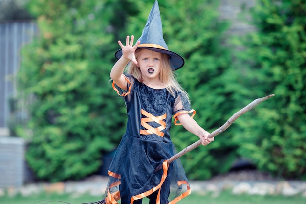 Happy girl in halloween costume with jack pumpkin.Trick or treat