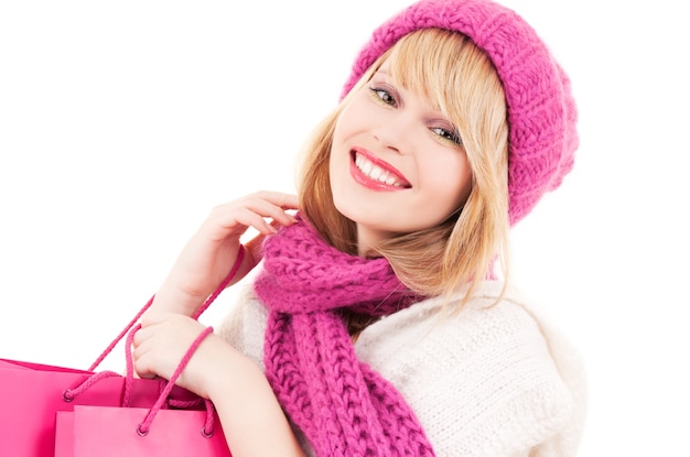 happy girl in hat with pink shopping bags