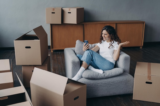 Happy girl having video call on phone showing her dream house Mortgage loan concept