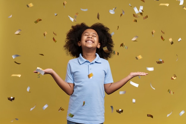 Happy girl jumping surrounding by confetti