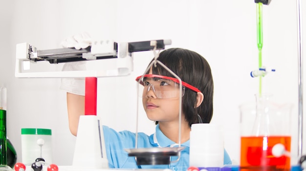 Happy girl kid in science laboratory 