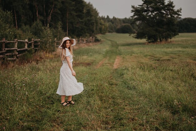 Happy girl Long hair White dress A hat with a brim