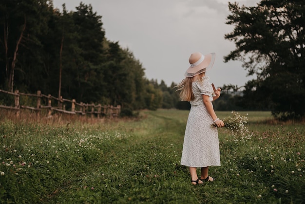 Happy girl Long hair White dress A hat with a brim